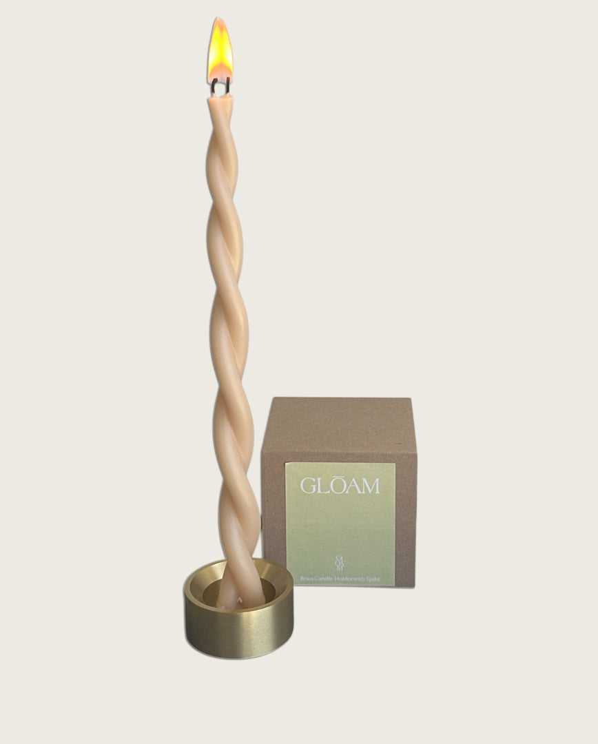 GLŌAM spike golden brass candlestick, a versatile taper candle holder that fits Classic, Twisted, and stubby candles, solid polished brass packaged in a gift box.