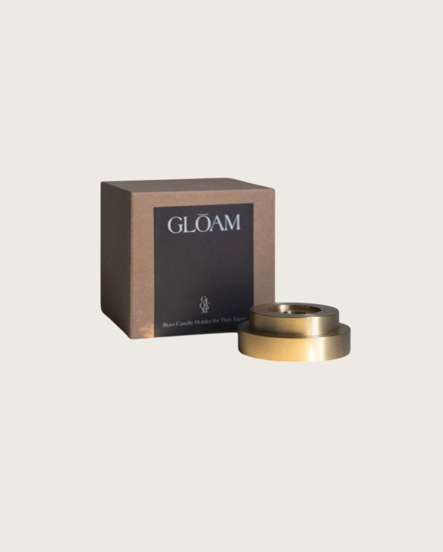 GLŌAM thin taper golden brass holder, a sculptural minimalist brass base made for Thin beeswax tapers, solid polished brass, packaged in a gift box.