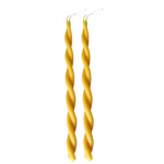 A pair of GLŌAM hand-twisted beeswax candles in natural, a yellow hue, crafted with plant-based pigments.