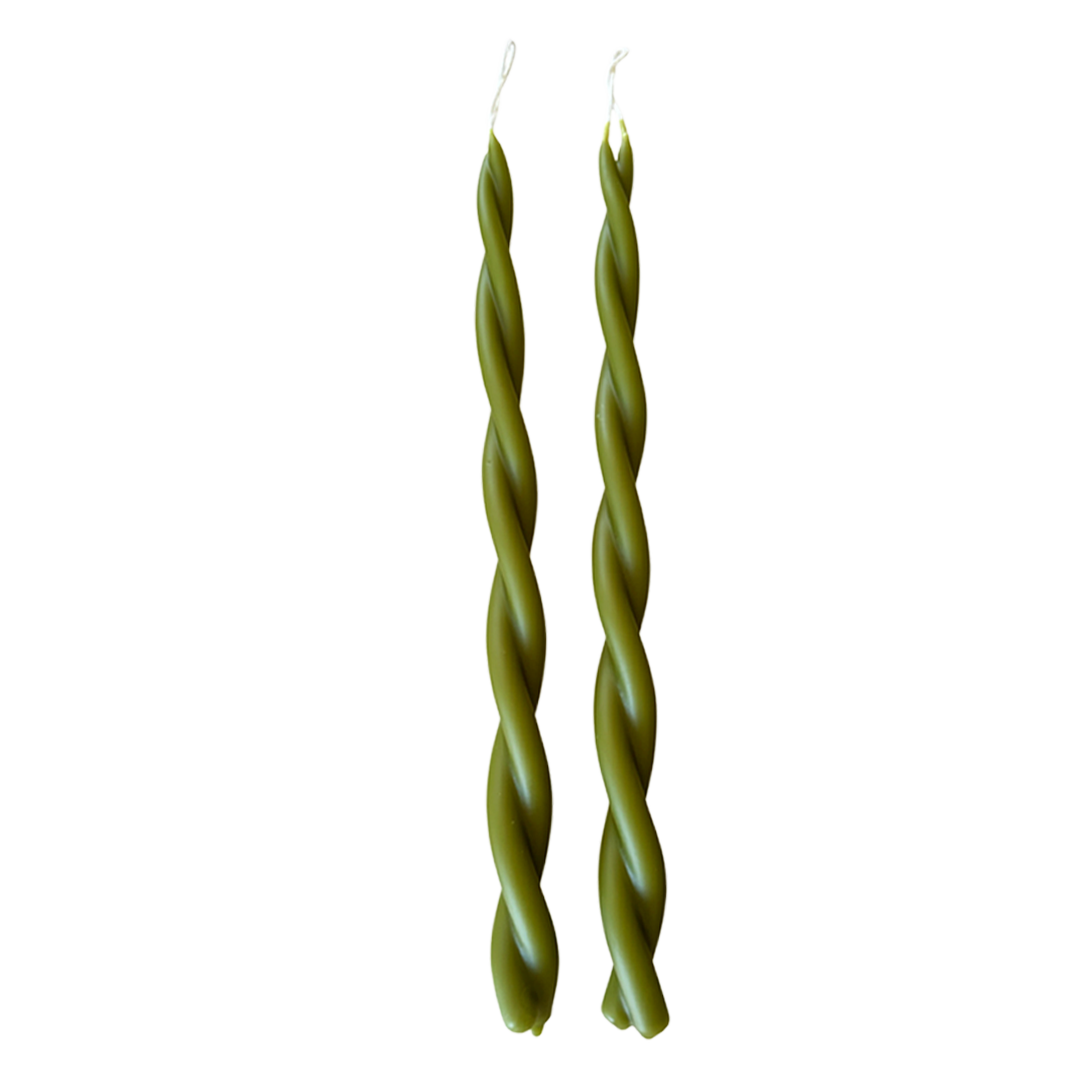 A pair of GLŌAM hand-twisted beeswax candles in Martini, crafted with plant-based pigments.
