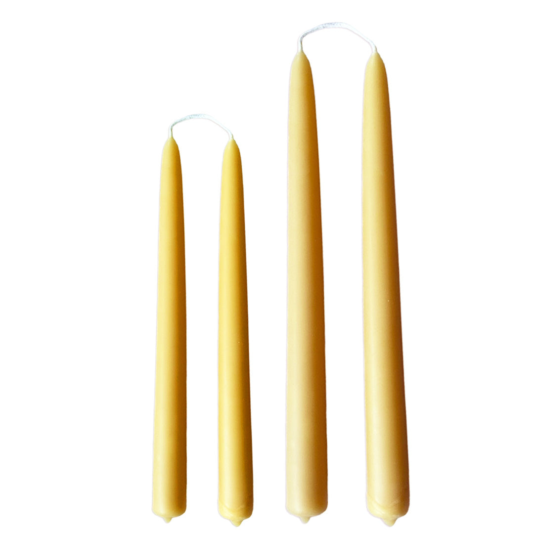 Hand-dipped beeswax taper candles in yellow natural, crafted with plant-based pigments for a luxurious look.