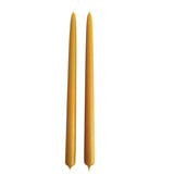 A pair of pure beeswax classic taper candles, hand dipped, no drip, in natural beeswax color, yellow hue