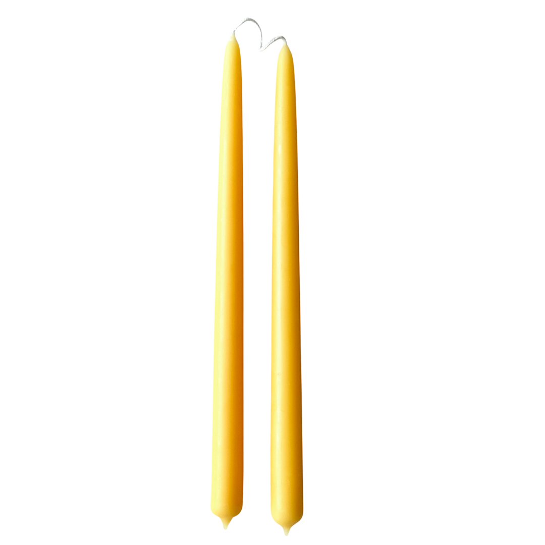 A pair of pure beeswax classic taper candles, hand dipped, no drip, in Natural beeswax color, yellow hue