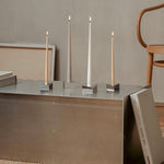 The Reflector, minimalist, modern candle holders Designed by STOFF Nagel, Grouped together small and large creating  grouped together a movement of light and rythm.