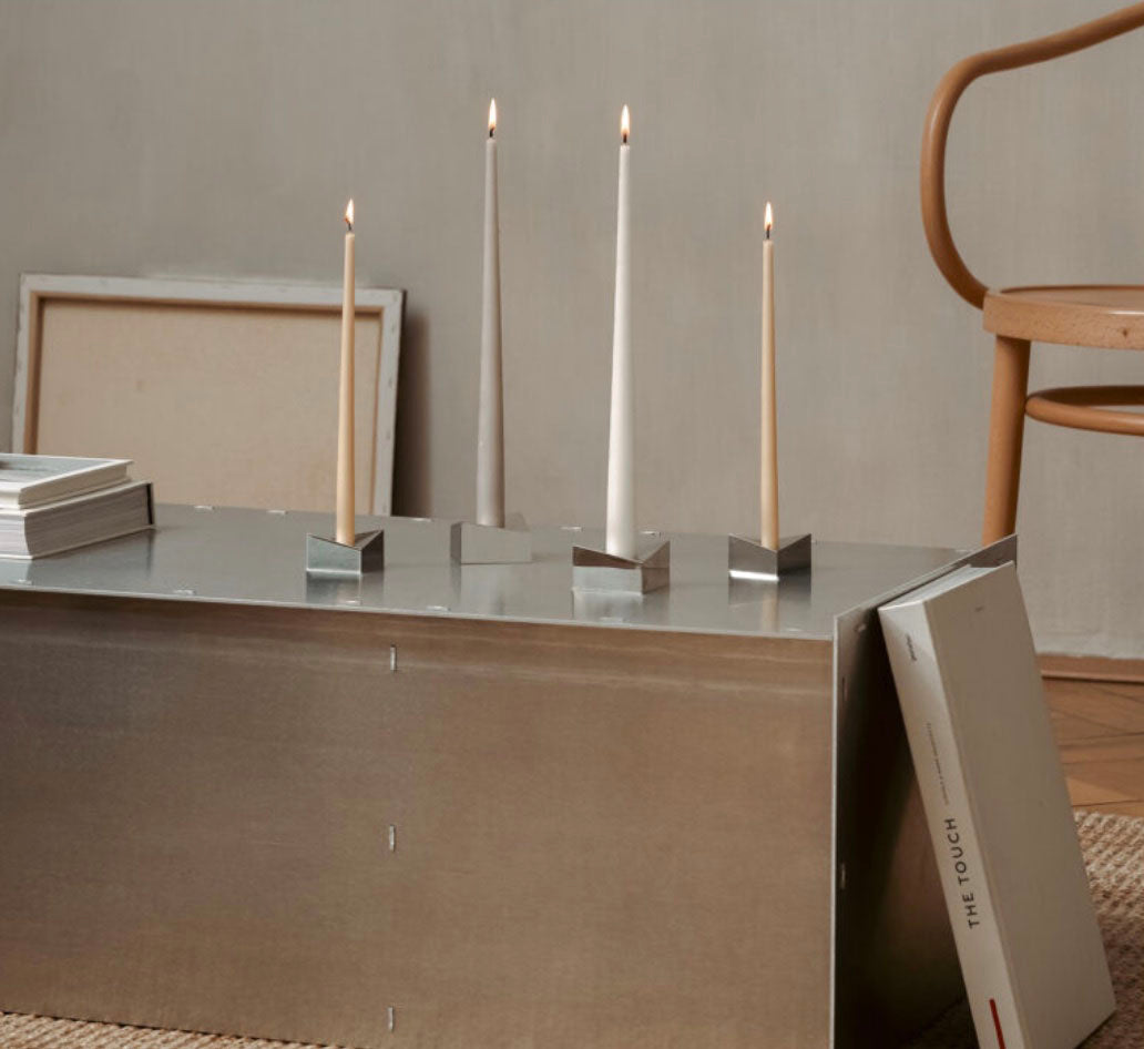The Reflector, minimalist, modern candle holders Designed by STOFF Nagel, Grouped together small and large creating  grouped together a movement of light and rythm.