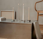 The Reflector, minimalist, modern candle holders Designed by STOFF Nagel, Grouped together small and large creating  grouped together a movement of light and rythm.