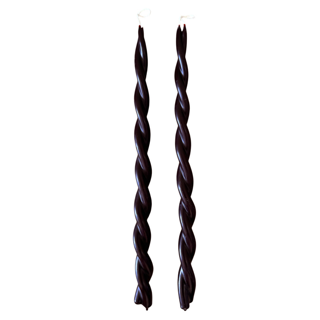 A pair of GLŌAM hand-twisted beeswax candles in Creme De cassis, a chocolate- brown hue, crafted with plant-based pigments.