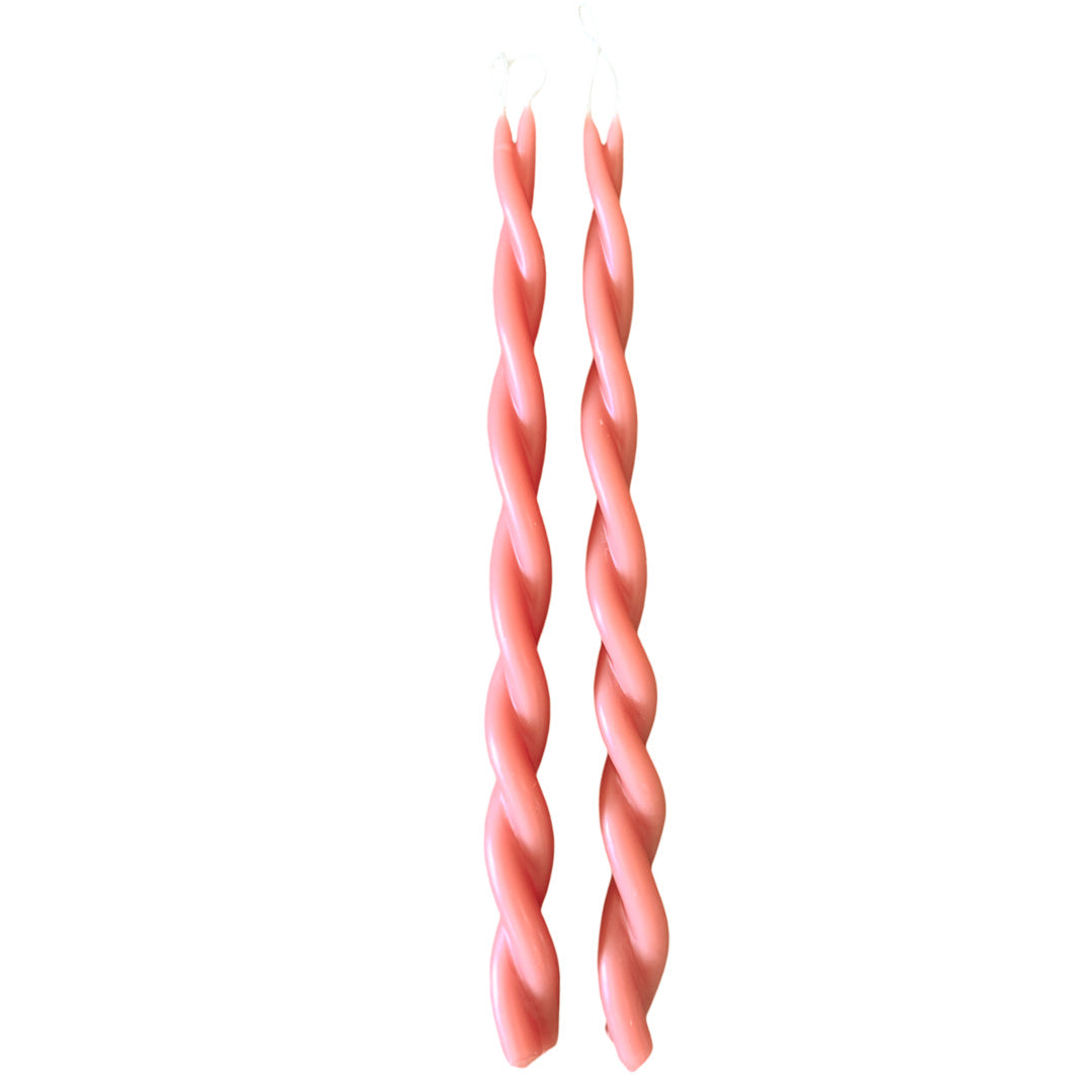 A pair of GLŌAM hand-twisted beeswax candles inMacaron, a peach-pink hue, crafted with plant-based pigments.