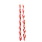 A pair of GLŌAM hand-twisted beeswax candles inMacaron, a peach-pink hue, crafted with plant-based pigments.