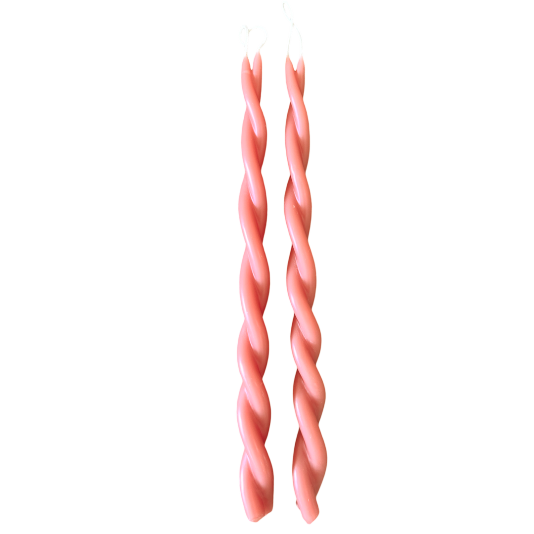 A pair of GLŌAM hand-twisted beeswax candles inMacaron, a peach-pink hue, crafted with plant-based pigments.