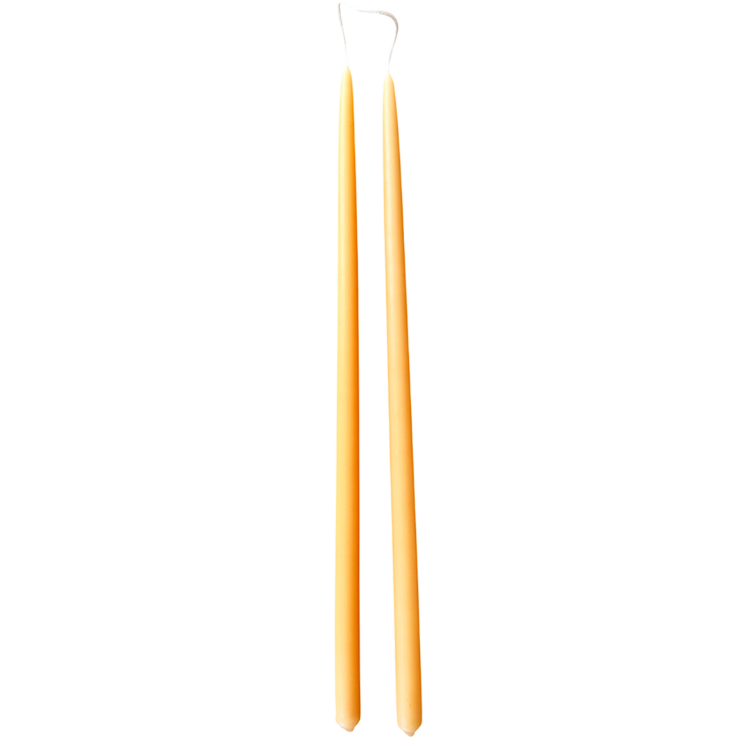 A pair of hand-dipped, thin, long, taper beeswax candles hand-dipped in Marigold