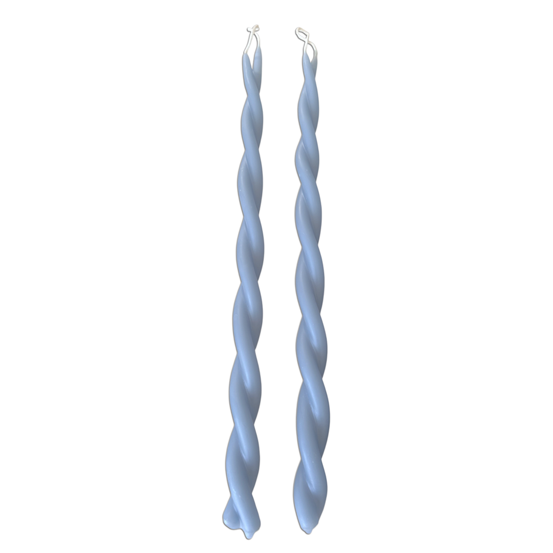 A pair of GLŌAM hand-twisted beeswax candles inMiramar Blue, crafted with plant-based pigments.