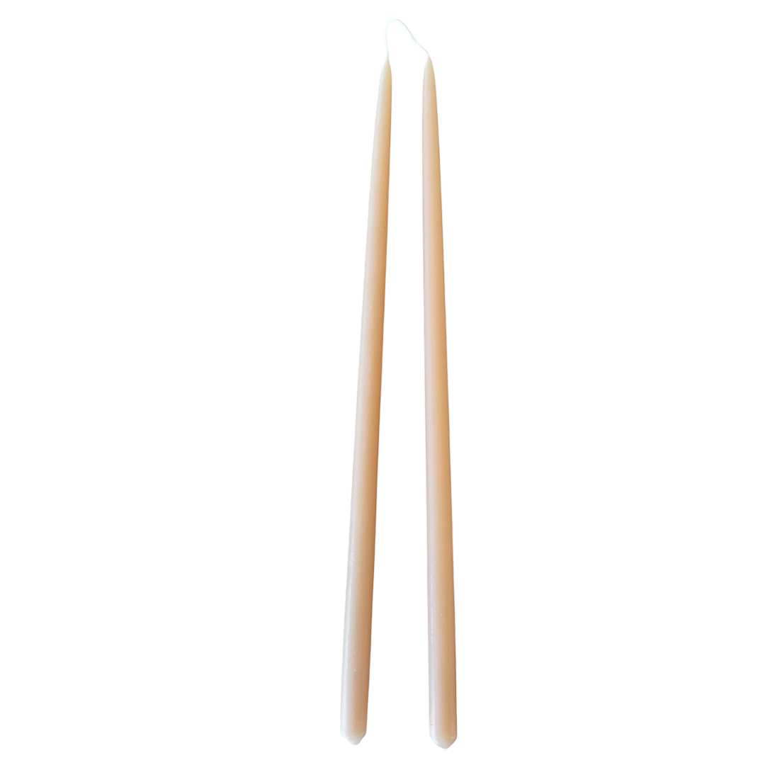 A pair of thin taper beeswax candles, hand-dipped, no dripnon-drip, in Marzipan.