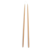 A pair of thin taper beeswax candles, hand-dipped, no dripnon-drip, in Marzipan.