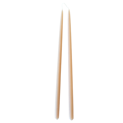 A pair of thin taper beeswax candles, hand-dipped, no dripnon-drip, in Marzipan.