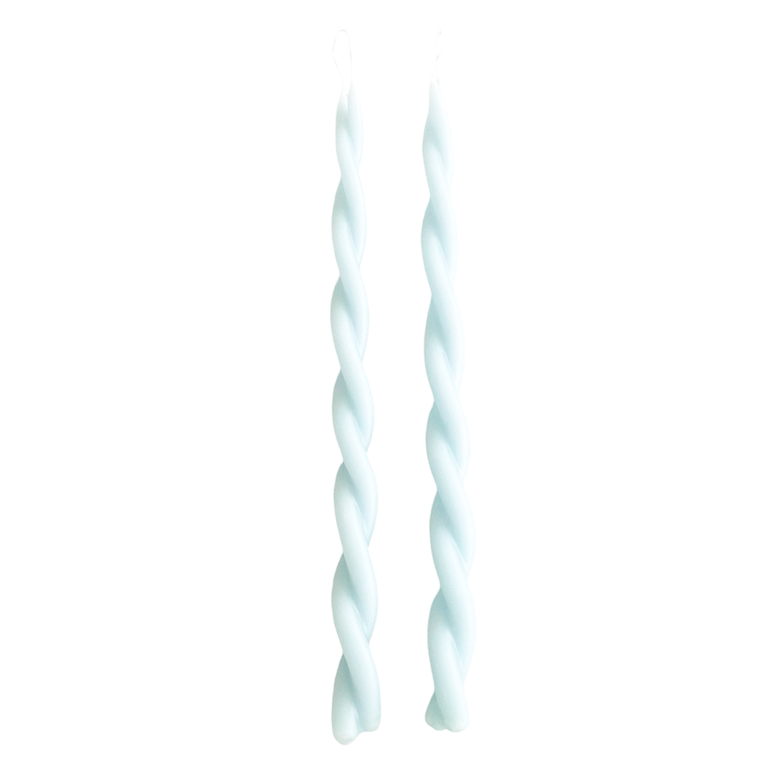 A pair of GLŌAM hand-twisted beeswax candles in Azure, light-blue hue, crafted with plant-based pigments.