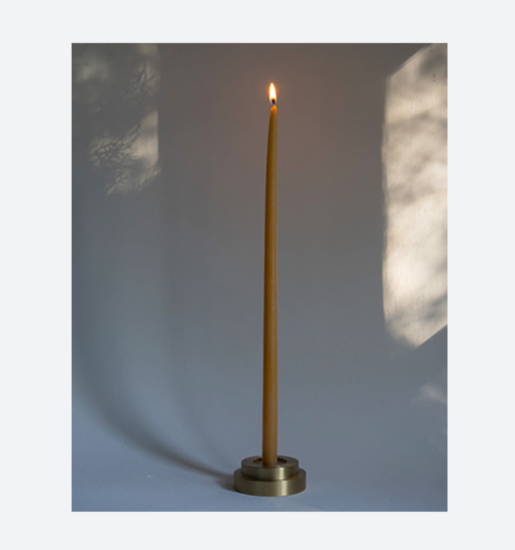 Designed  by GLŌAM this holder fit our Skinny Tapered Candles. Made from solid brass, it has a paperweight-like feel. 