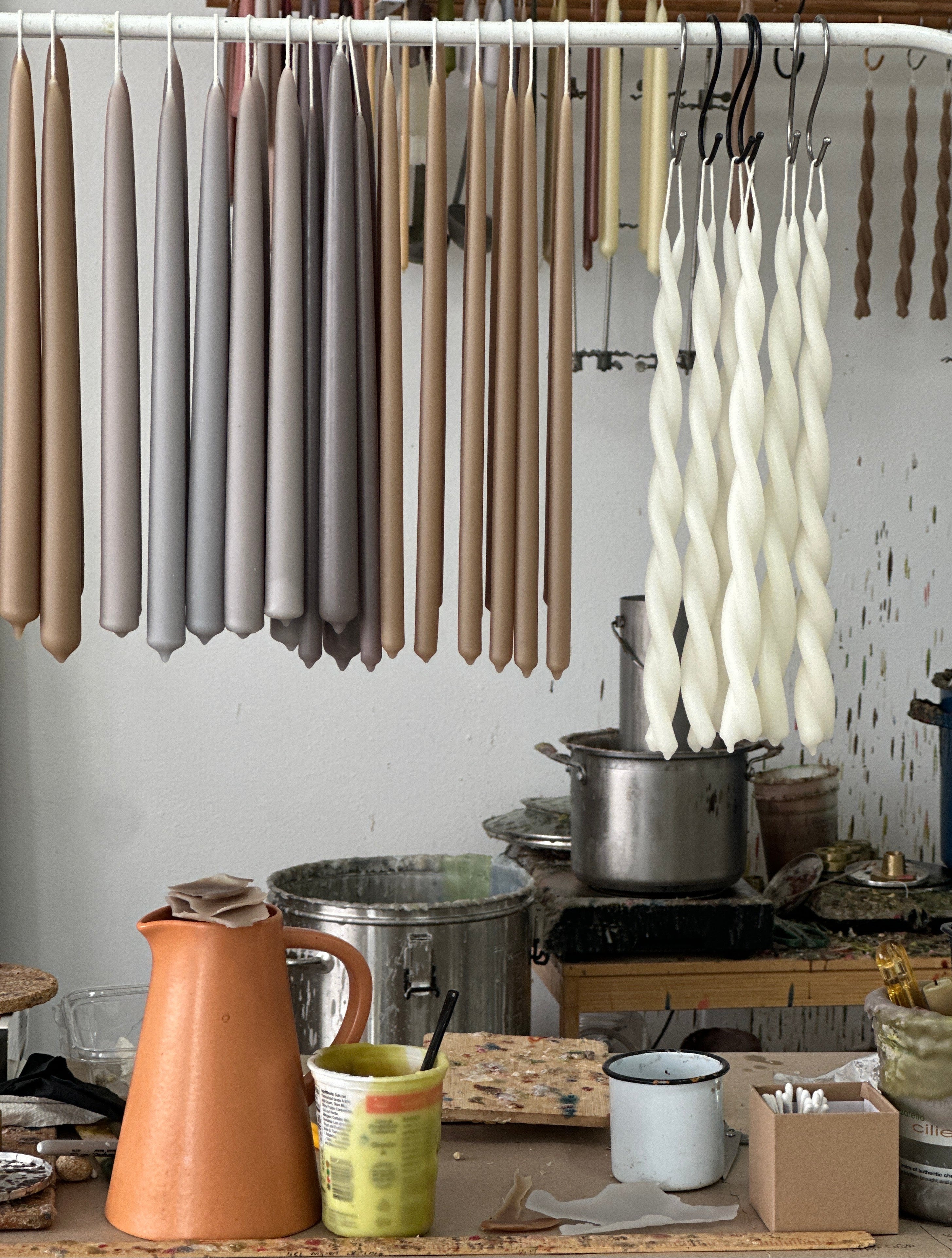 GLŌAM GOODS hand-dipped beeswax Classic Taper candles hanging in the Santa Barbara studio — natural plant-based pigments, responsible beekeepers, made by hand