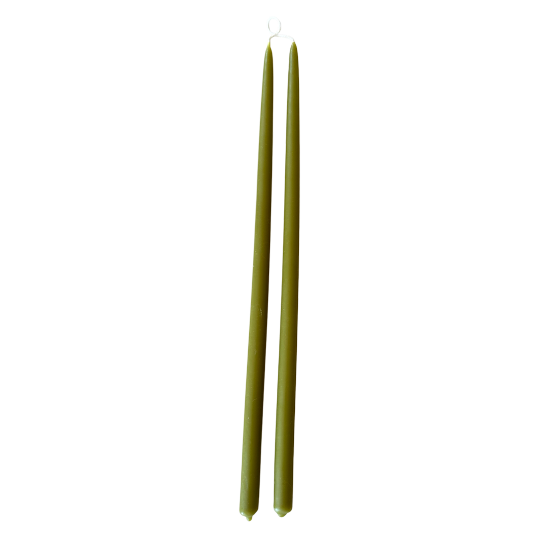 A pair of thin and long taper pure beeswax candles hand-dipped  in martini green glow, long burn