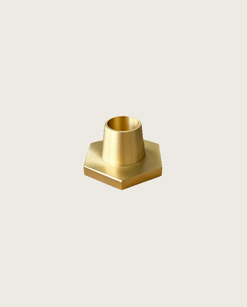 GLŌAM hexagon candlestick, a golden brass taper candle holder for Classic and Twisted beeswax tapers, solid polished brass.