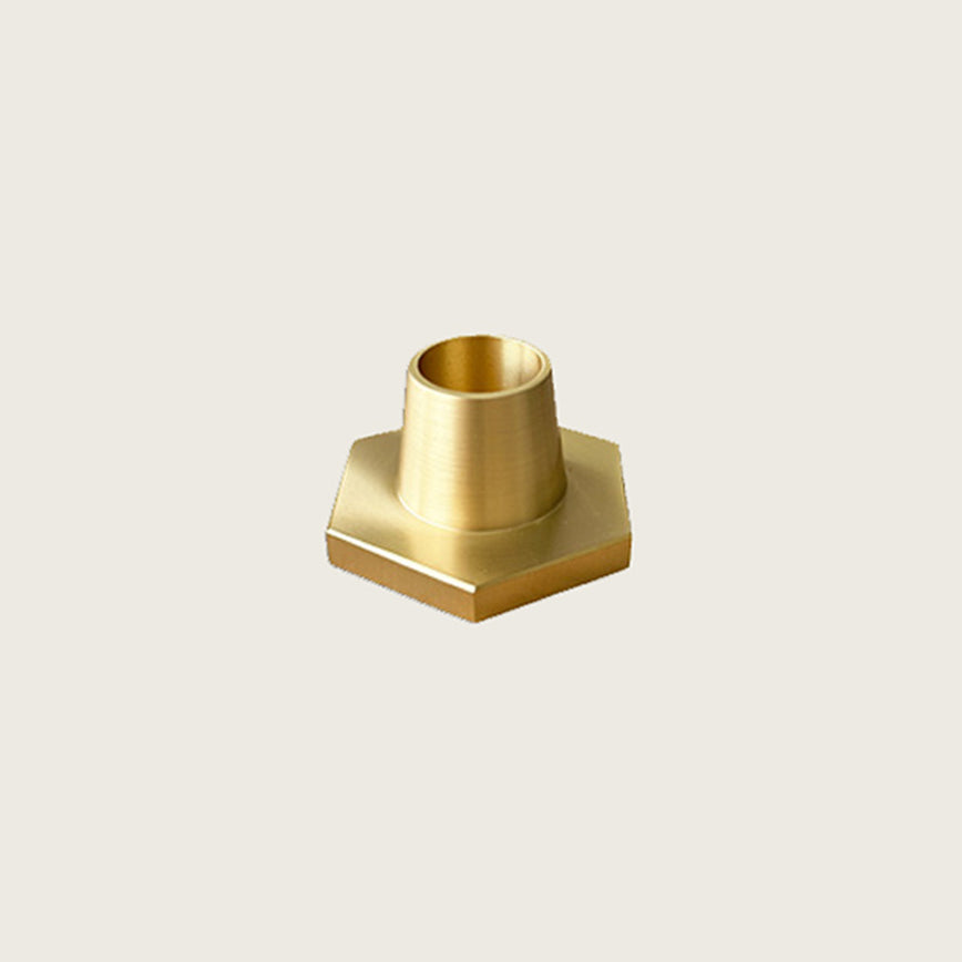 GLŌAM hexagon candlestick, a golden brass taper candle holder for Classic and Twisted beeswax tapers, solid polished brass.