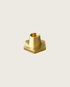 GLŌAM hexagon candlestick, a golden brass taper candle holder for Classic and Twisted beeswax tapers, solid polished brass.