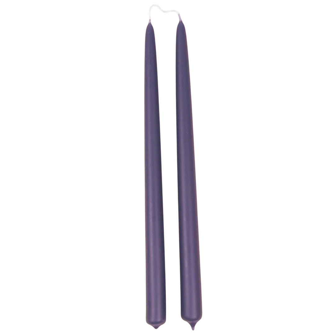 A pair of Maritime Blue 12-inch hand-dipped beeswax taper candles in deep bluish purple, GLŌAM.