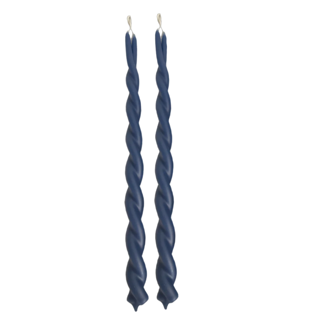 A pair of GLŌAM  dripless, hand-twisted beeswax candles in Le Levandou Blue, a royal-blue hue, crafted with plant-based pigments.