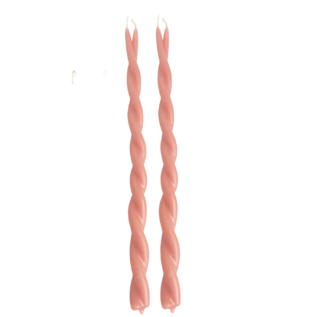A pair of GLŌAM hand-twisted beeswax candles in Sal-De-Maras, an orange-pink hue, crafted with plant-based pigments.