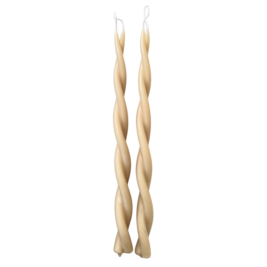 A pair of GLŌAM hand-twisted beeswax candles in Tan-beige hue, crafted with plant-based pigments.