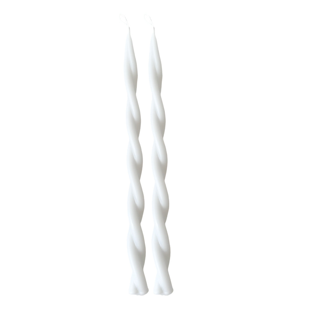 A pair of GLŌAM hand-twisted beeswax candles in alpine glow, a clean white hue, crafted with plant-based pigments.