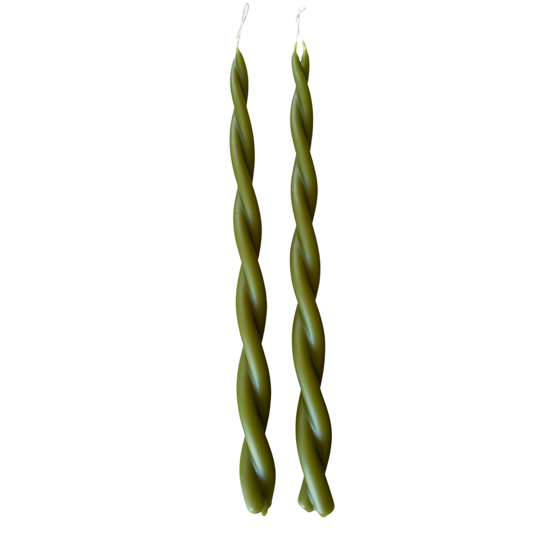A pair of GLŌAM hand-twisted beeswax candles in Martini, crafted with plant-based pigments.