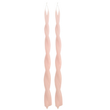 A pair of GLŌAM hand-twisted beeswax candles in scallop, a light-pink hue, crafted with plant-based pigments.