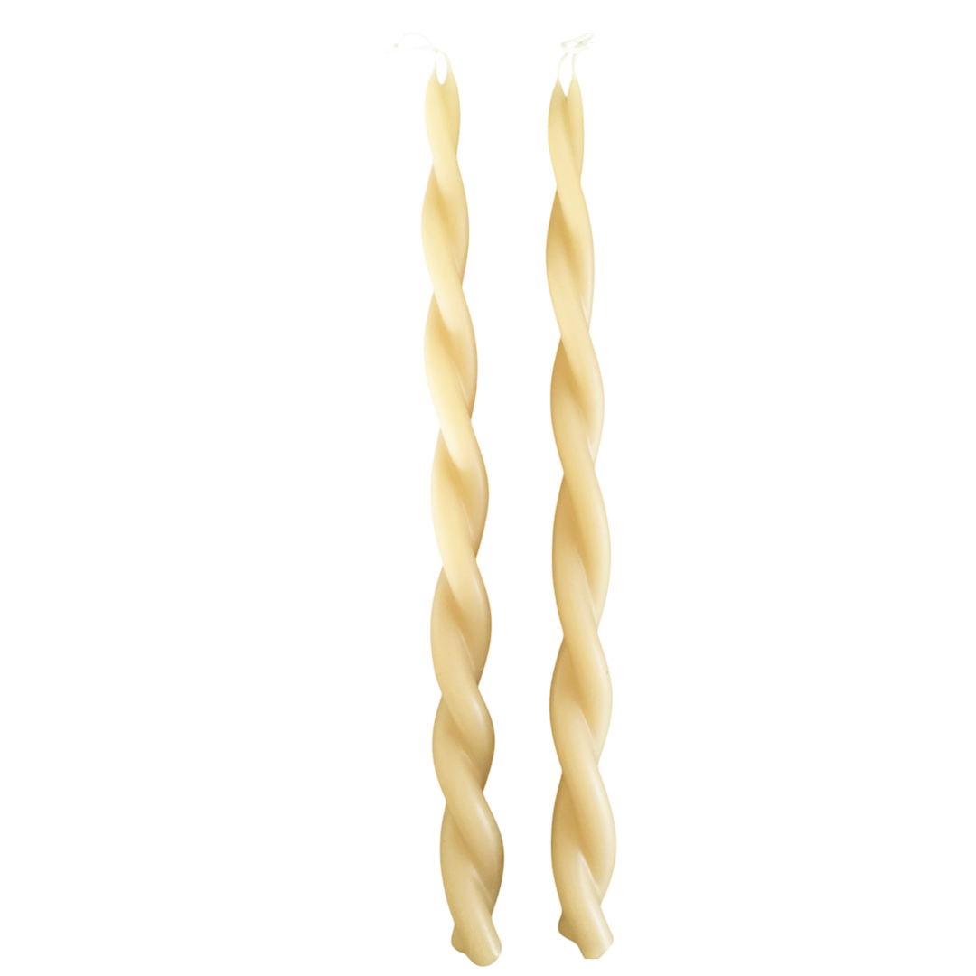 A pair of twisted pure beeswax taper candles plant-based pigments in yellow butter color, hand crafted for a luxurious look