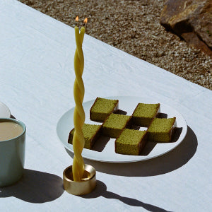 GLŌAM spike golden brass candlestick, a versatile taper candle holder that fits Classic, Twisted, and Stubby candles, solid polished brass.