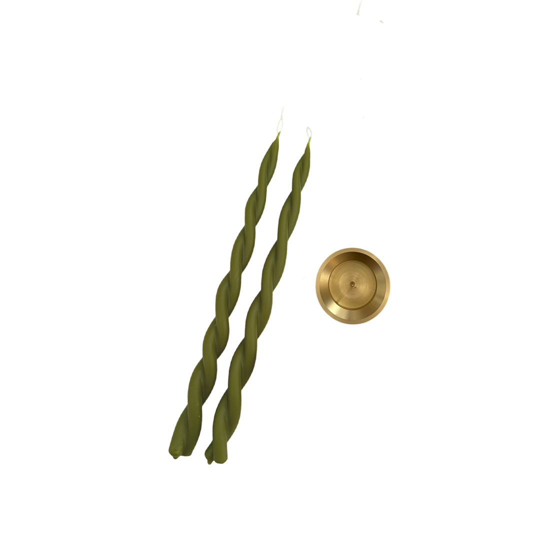A pair of beeswax twisted  candles in martini green with a solid brass spike holder