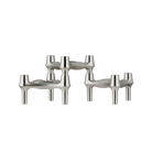 STOFF Nagel BMF candle holders in brushed chrome, three faceted modular holders with continuous flowing lines and a soft satin finish