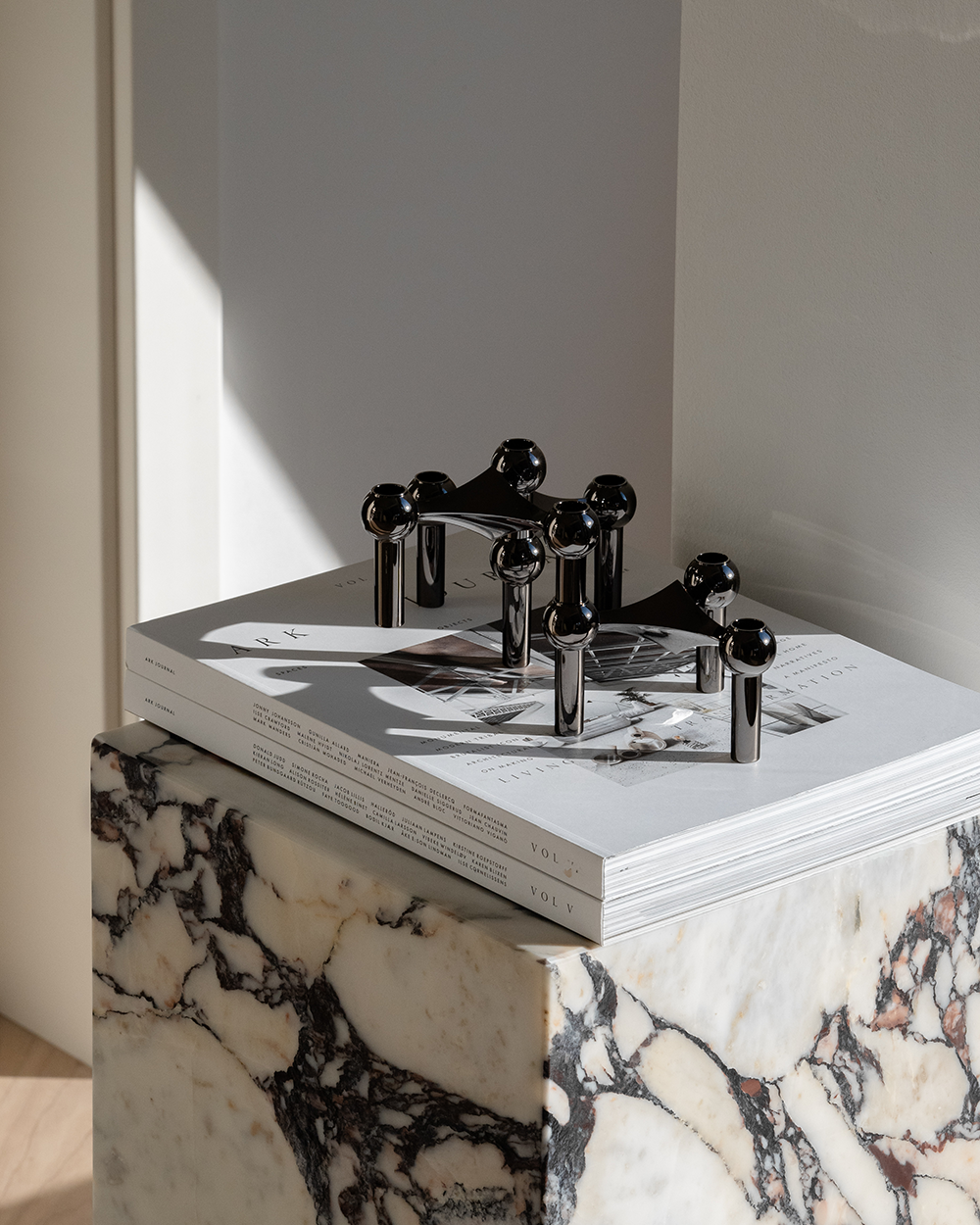 The iconic STOFF Nagel candle holder in dark metallic  edition is a futuristic expression brings elegance and a masculine vibe into the interior decor.