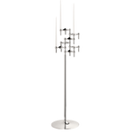 STOFF Nagel floor stand in chrome holding six original candle holders with white taper candles, a freestanding modular sculpture
