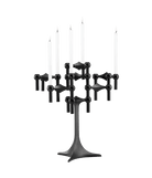 STOFF Nagel stand in black built up with modular holders into a full candle composition with lit tapers