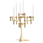 STOFF Nagel stand in solid brass built up with modular holders into a full candle composition with lit tapers