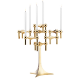 STOFF Nagel stand in solid brass built up with modular holders into a full candle composition with lit tapers
