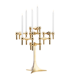 STOFF Nagel stand in solid brass built up with modular holders into a full candle composition with lit tapers