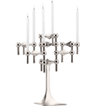 STOFF Nagel stand in chrome built up with modular holders into a full candle composition with lit tapers