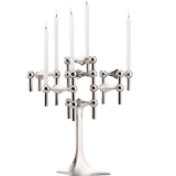 STOFF Nagel stand in chrome built up with modular holders into a full candle composition with lit tapers