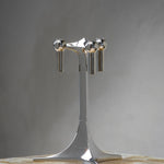 STOFF Nagel tabletop stand in chrome on a marble surface, showing the stemmed base and three candle cups