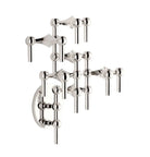 STOFF Nagel chrome wall hanger with modular candle holders built into a tall vertical arrangement, holding taper candles