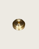 GLŌAM thin taper golden brass holder, a sculptural minimalist brass base made for Thin beeswax tapers, solid polished brass