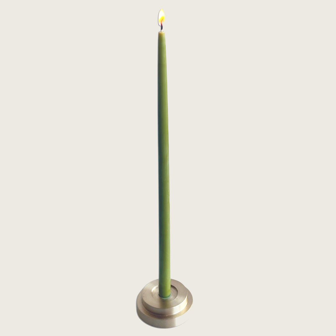 GLŌAM thin taper golden brass holder, a sculptural minimalist brass base made for Thin beeswax tapers, solid polished brass