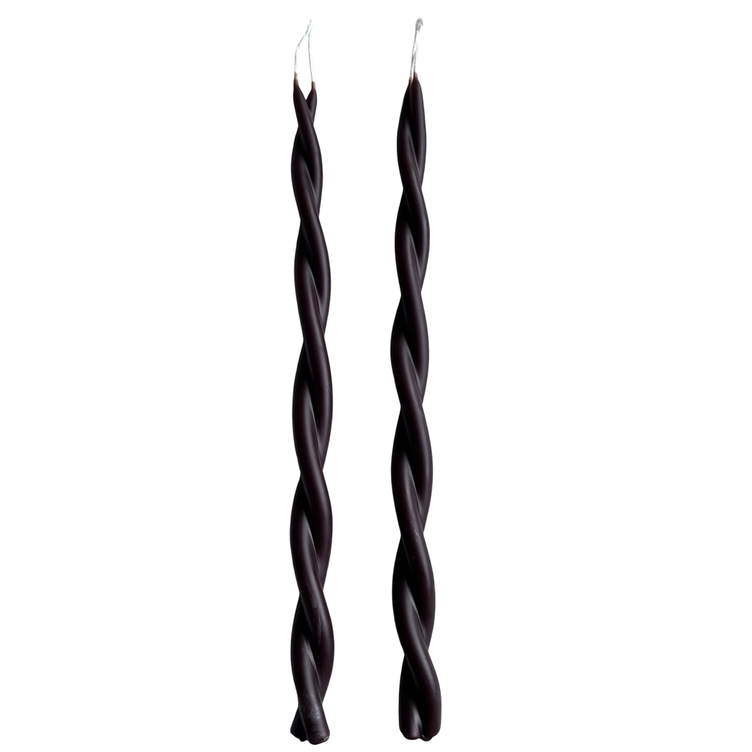 A pair of twisted pure beeswax taper candles infused with plant-based pigments in creme de cassis - dark chocolate Brown